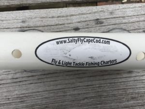 A faded Salty Fly Fishing Charters Label