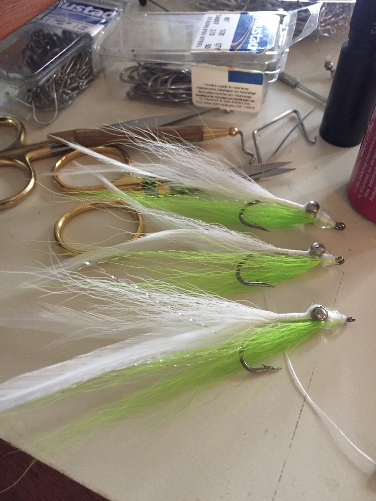 Clouser flies on a fly tying table