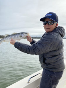 the season begins with Capt Avery Revere holding a striped bass caught on the fly