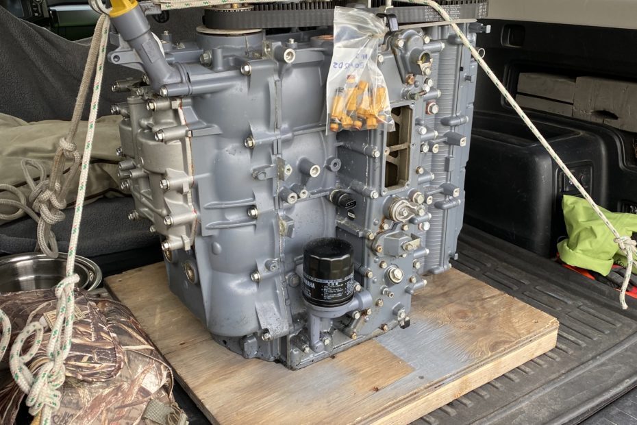 Picture of an engine block strapped into the back of a car