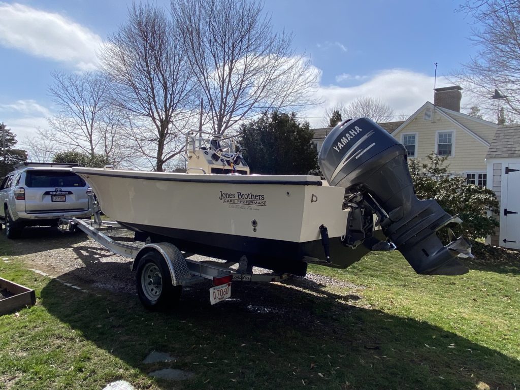 Jones Brother 20' Center console on a trailer with a fully assembled outboard on the stern.