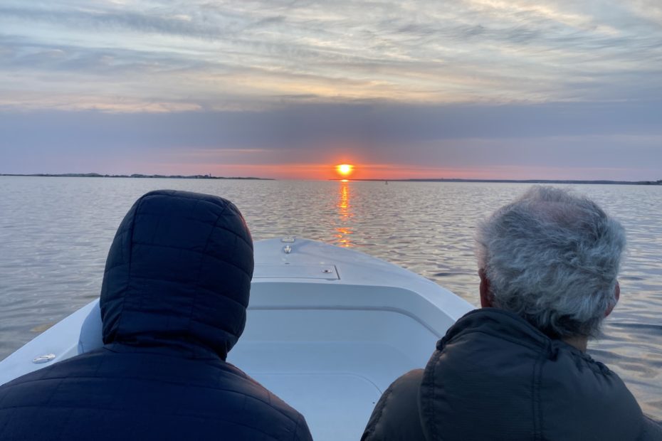 5:30am start as we drive into the sunrise, two heads photographed from behind