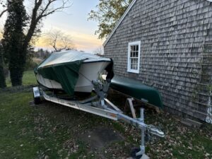 boat on a trailer with a green tarp on it