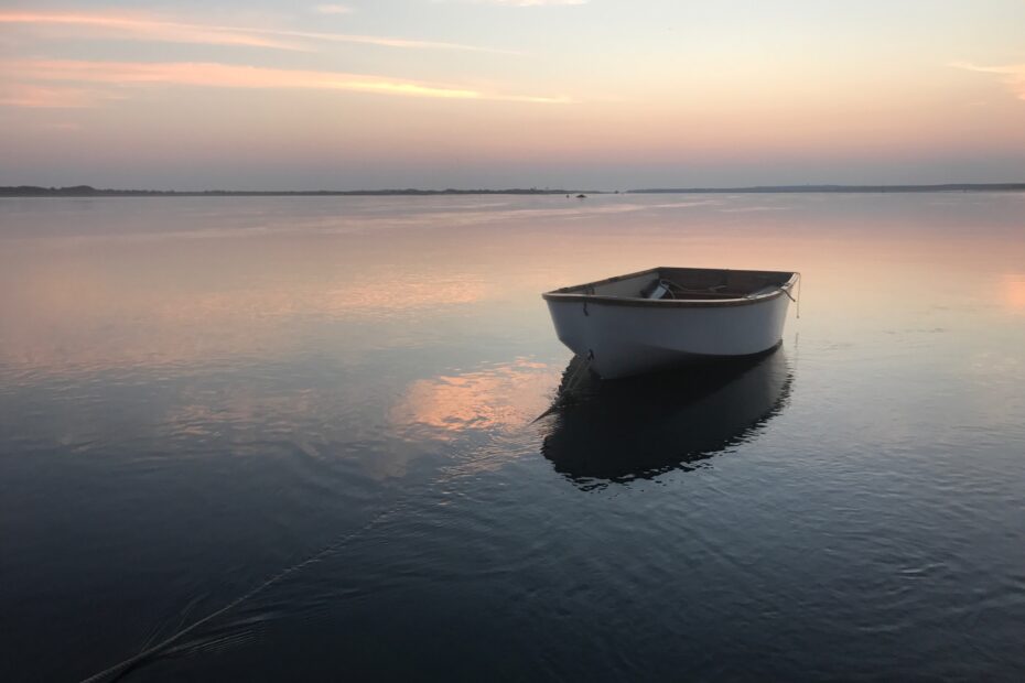 Row on calm waters with subtle sunset colors