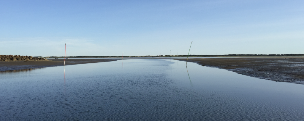 Barnstable Harbor channel with mudflats on either side of the channel